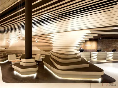 Modern interior design reception area with concrete walls, reception desks, and chandeliers at resort.
