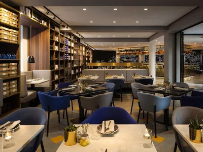 Modern, minimalist restaurant interior with a mid-century desk