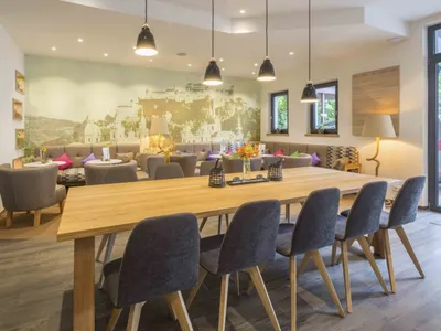A cozy café interior with wooden furniture and comfortable seating areas.