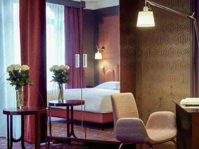 Modern hotel room featuring a textured paper wall and contemporary furniture.