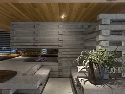Concrete living room with industrial design elements and minimalist furniture.