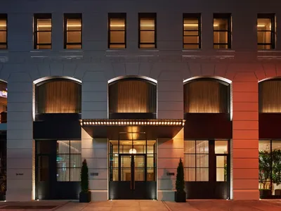 Modern hotel entrance featuring brick and concrete materials.