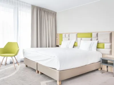 Modern minimalist bedroom with a soft, neutral textile color palette.