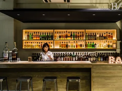 A well-stocked bar with bottles of alcohol lined up on shelves