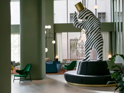 A modern lobby featuring a striking black and white striped tower sculpture.