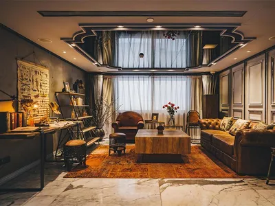 Industrial living room featuring leather furniture, wooden table, and decorative elements.