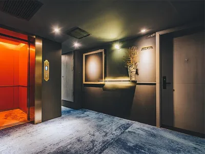 Modern hotel lobby featuring metallic finishes and contemporary design elements.
