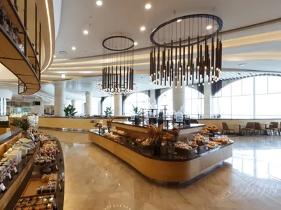 Modern restaurant cafe interior with concrete and wood finishes, showcasing sleek design features.