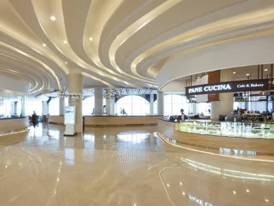 A modern restaurant interior with marble floors and curved lighting features