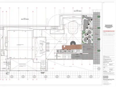 Floor plan of a modern restaurant interior with a metal driveway, wooden seating, glass walls, and concrete flooring.