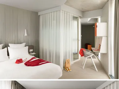 A modern minimalist hotel bedroom with a textured wallpaper accent wall and curtains, featuring a comfortable bed with white
