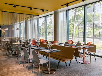 Modern restaurant interior with minimalist design and contemporary materials.