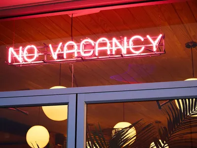 A neon sign reading 'NO VACANCY' outside a hotel or restaurant.
