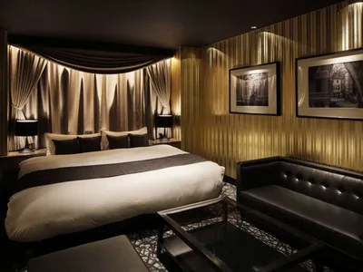 Modern hotel room featuring metallic gold decorative panels and minimalist design elements.