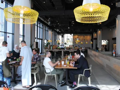 Industrial-style restaurant interior with metallic pendant lights and modern design