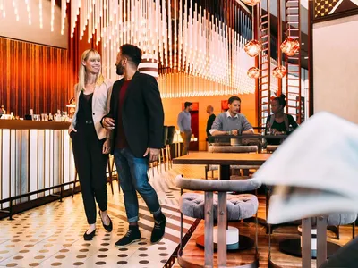 A modern restaurant bar interior with contemporary design elements and lighting fixtures.