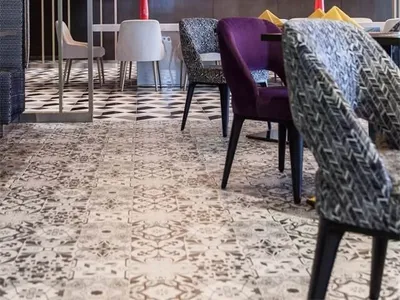 Modern restaurant interior with checkered floor, geometric ceiling pattern, and yellow decorative elements.