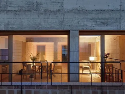 Concrete interior of a living room with warm lighting