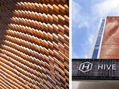A modern brick hotel building with a unique design.