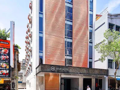 Modern office building with brick facade and glass windows.