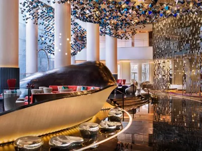 An image of a modern hotel lobby with metallic acrylic panels on the walls.