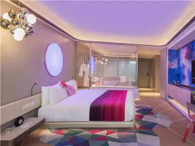 Luxurious bedroom with modern design elements and a mix of colors and materials.