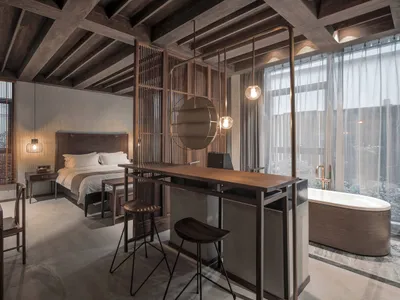 A minimalist bedroom suite featuring wooden furniture and decor.