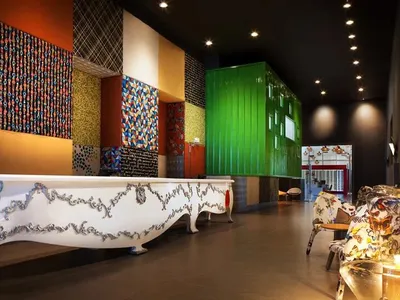 Hotel reception lobby area with decorative textiles on walls and furniture, designed to welcome guests.