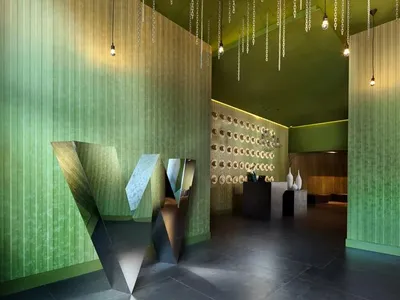 A modern restaurant lobby with metallic green features