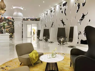 Modern, minimalist lounge area with concrete, marble, and metal accents.