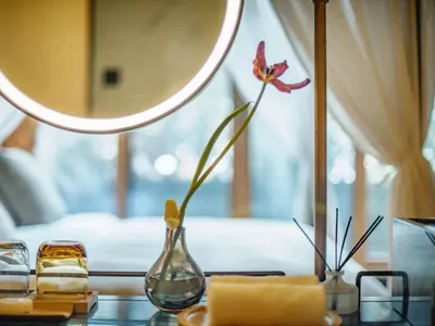 A modern bedroom with glass elements and decorative items.