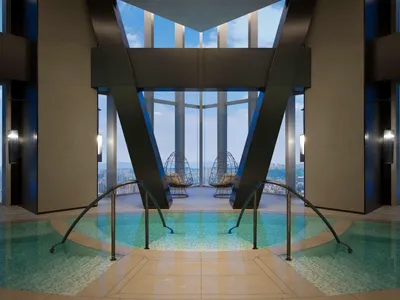An indoor pool area with glass and marble features, designed for relaxation and luxury in a hotel suite.