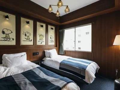 A modern hotel room with wooden walls and a window.