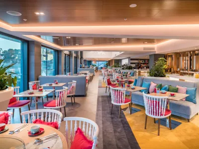 Modern restaurant interior with concrete, wood, and glass materials