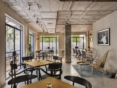 Industrial style restaurant interior with brick walls, concrete floors, and eclectic artifacts