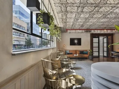 Modern industrial-style restaurant interior with metal furniture and decor.
