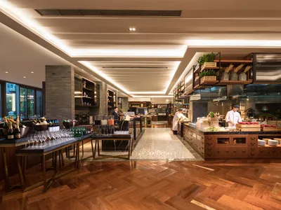 A modern restaurant interior featuring a wooden floor and minimalist design.