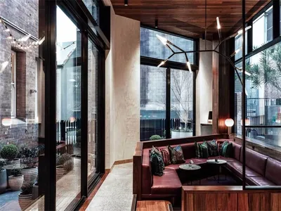 Modern, industrial restaurant interior with brick walls, concrete floors and wooden accents.