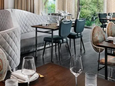 Modern restaurant interior with large windows and glass curtains