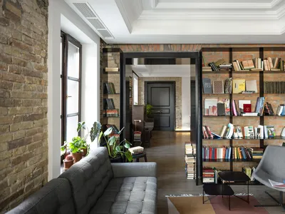 Industrial-style living room with exposed brick walls and modern furniture.