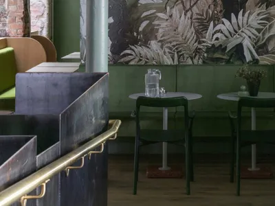 A modern industrial restaurant interior with concrete and leather materials.