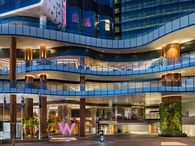 Modern design hotel lobby featuring glass walls and wooden structural elements