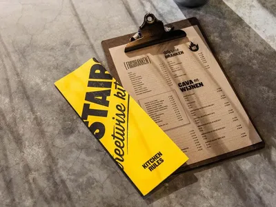 A clipboard with a paper menu featuring industrial design elements.