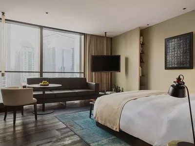 Modern hotel suite featuring a combination of wood and textiles for a contemporary and stylish ambiance.