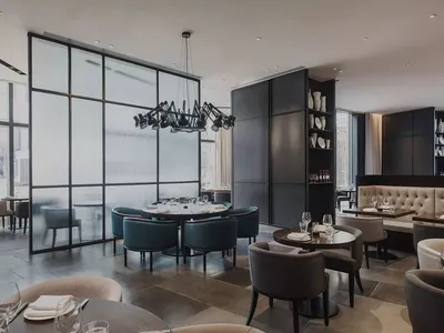 A modern restaurant interior featuring metal and glass materials.