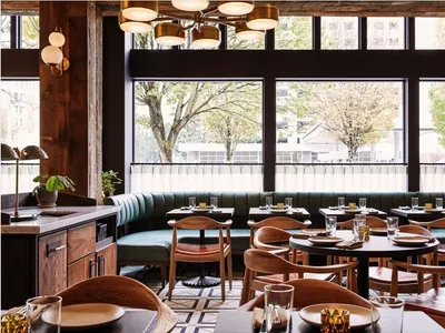 A modern, industrial-styled restaurant interior with wood, leather, and metal materials.