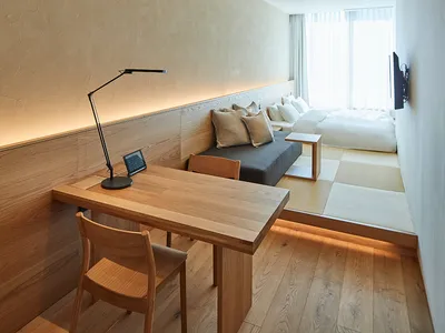 Minimalist bedroom featuring wooden furniture and a cozy atmosphere.