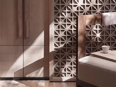 Modern minimalist bedroom featuring wooden furniture and a patterned wood accent wall.
