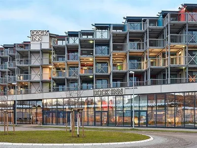 Modern hotel building with metal and glass structure.