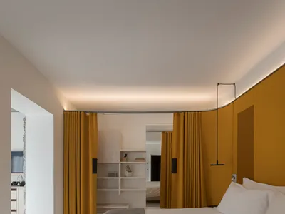 Modern minimalist bedroom featuring yellow curtains